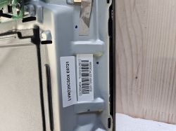 Close-up of metal device casing with identification stickers and serial numbers