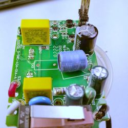 Circuit Board with Electronic Components Circuit board with various electronic components, including capacitors and a plug.