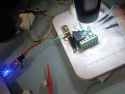 Close-up of an electronic circuit with a connected module via wires and USB UART.