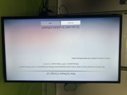 A TV displaying an upside-down software update prompt.