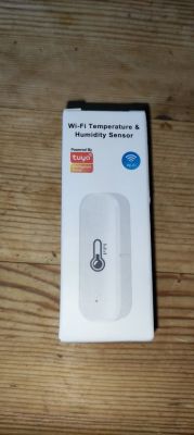Wi-Fi Temperature and Humidity Sensor Box Box of a white Wi-Fi temperature and humidity sensor with Powered by Tuya logo and Wi-Fi icon.