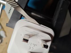 Opening a Tuya Smart Plug Tuya smart plug in a vise with a tool for opening the casing.