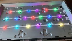 Panel with multicolored RGB LEDs mounted in rows on a metallic surface