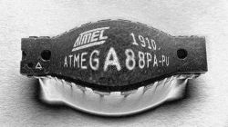 Counterfeit ATmega88PA-PU microcontroller with sanded and reapplied labels.
