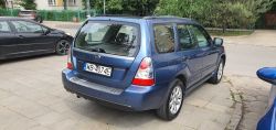 Blue Subaru Forester car parked on the street.