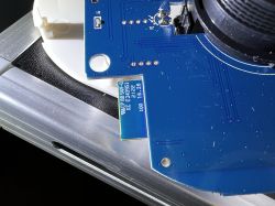 PCB with Optical Smoke Detector Close-up of a PCB with blue laminate and an optical smoke detector attached.