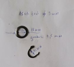 Damaged circlip and washer with size markings on a white background.