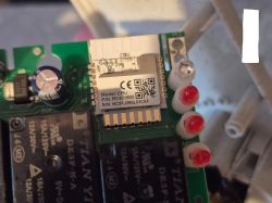 Electronic module with capacitor, relays, LEDs, and a CBU communication module on a PCB.