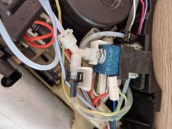 Widok elektrozaworu CEME z podłączonymi przewodami i wężykami w ekspresie do kawy.
