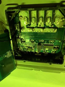 Interior of an electronic device with visible circuit elements and connections.