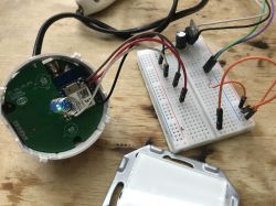 Light Switch Connection to Breadboard Interior of a light switch with electronic components connected to a breadboard.