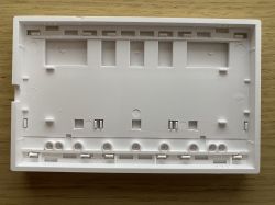 Bottom of a plastic triple switch casing.