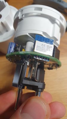 Close-up of the inside of a plug with electronics, showing screwdrivers used in the plug.