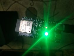 ESP32 module with a glowing green LED.