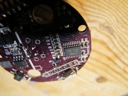 Close-up of the inside of a flammable gas alarm showing the Runjet RJM8L151F6P6 chip on a circuit board.