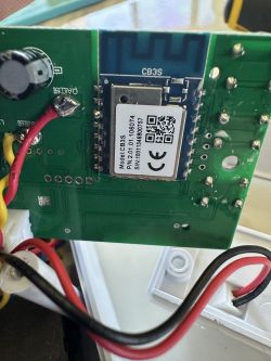 Close-up of an electronic device's circuit board, showing model CB3S and various colored wires.