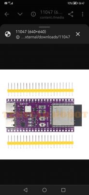 Microcontroller board with connectors and electronic components on a purple background.