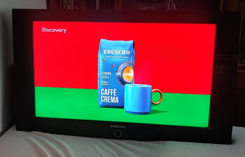 Functioning Samsung TV after flooding Samsung TV displaying an Eduscho coffee advertisement.