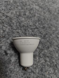SMART WIFI GU10 Bulb SMART WIFI GU10 LED bulb lying on a grey surface.