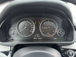 Car dashboard with speedometer and tachometer.