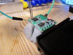 Testing an ELM327 OBDII Electronic Circuit Close-up of an electronic circuit with connected test wires.