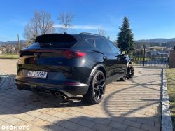 Black Cupra SUV, rear three-quarter view, parked on a driveway on a sunny day