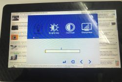 Small monitor screen showing blue OSD menu: Backlight, Brightness, Contrast, Sharpness over a web page