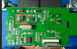 Close-up of a circuit board with a damaged component marked in a red square.