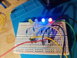 Circuit on a breadboard with five lit LEDs.