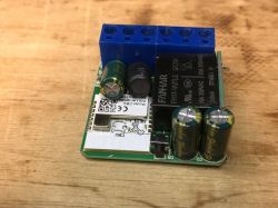 Close-up of the WSM16-W1 module with electronic components on a wooden background.