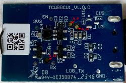 TCWBRCU1_V1.0.0 PCB with SMD Components Blue printed circuit board with electronic components, labels, and a QR code.