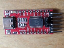 USB to UART converter module with FTDI chip on red PCB