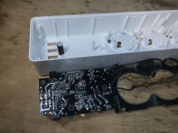 Interior of Woox R4027 Power Strip View of the interior of a power strip with exposed PCB and white casing.