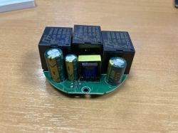 Circuit board with electronic components, including relays and capacitors.