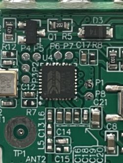 Close-up of a circuit board with an integrated circuit and component markings.