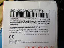 Product label on a white box with a barcode, IP camera description, and manufacturer details.