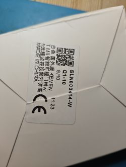 Label with QR code and markings on a white folded cardboard box