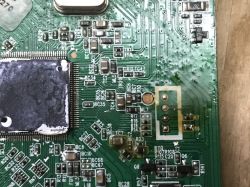 Close-up of a PCB section showing UART pads and surface-mount components.