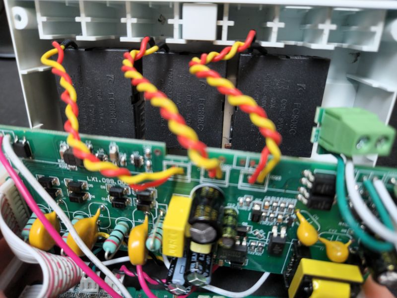 Interior of a Three-Phase Energy Meter Close-up of the interior of a three-phase energy meter with visible electronic components and colorful wires.