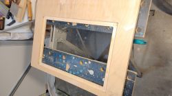 Wooden frame with cut-out and mounted brackets.