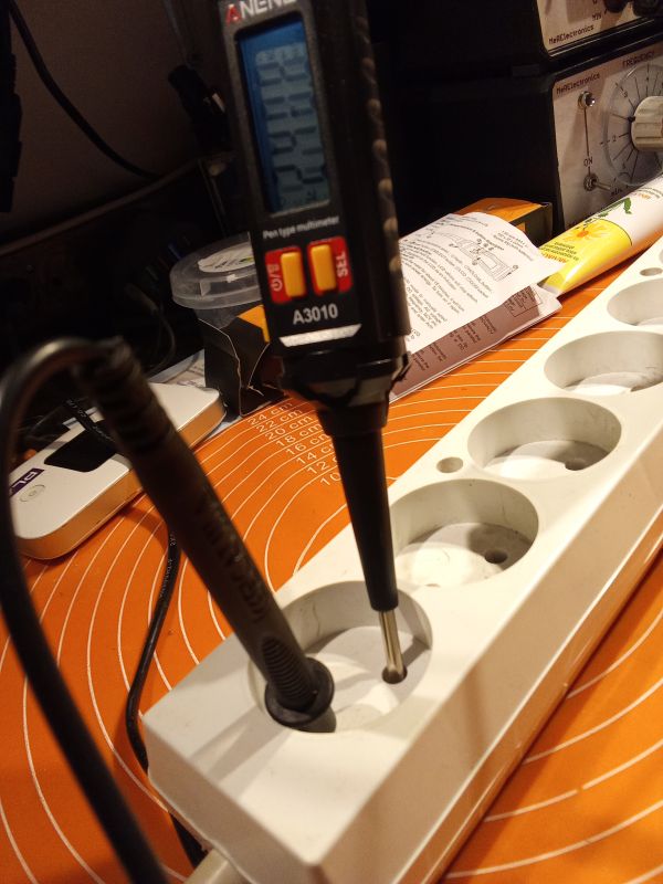 Miernik ANENG A3010 podczas pomiaru w listwie zasilającej