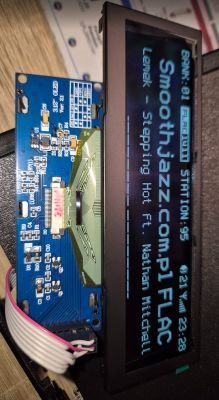 OLED display showing Smoothjazz.com.pl FLAC station next to a blue electronics PCB