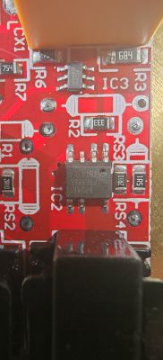 Zbliżenie czerwonej płytki PCB sterownika LED z układami IC2 i IC3 oraz rezystorami SMD