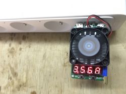 Inside a power strip: small fan on a PCB and a red LED segment display