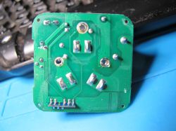 Printed Circuit Board with Soldering Points Green printed circuit board with visible traces and soldering points.