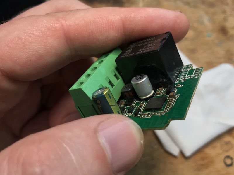 Wi-Fi Relay Module Featuring QFN-Packaged T34 Chip Relay module with QFN-packaged T34 chip held in hand
