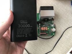 NXT Gear BY-K9 30000 mAh power bank with specs visible and tester showing 18.95 Ah