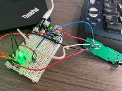 Breadboard with connected wires and an electronic sensor.