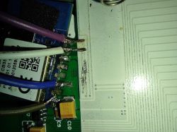 Close-up of a circuit board with soldered wires.