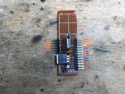 Prototype Board with WB2S Module and Labeled Pins Prototype electronic board with labeled pins on a wooden table.